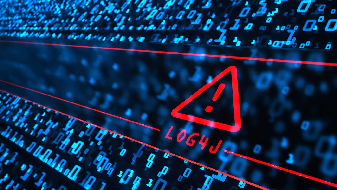 Man with a computer near server racks.